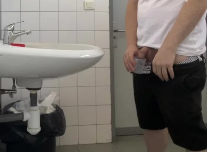 Guy Taking a Urine Sample in Hospital Toilets