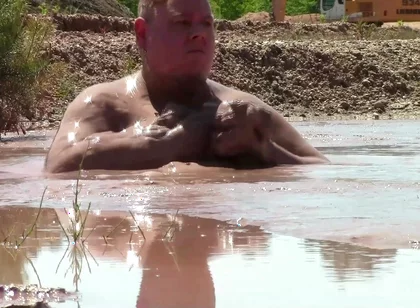 Deep, Creamy Brown Mud Bath in a Sand Pit