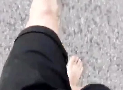 Jon Arteen Walks Barefoot on the Street Outdoors, the Boy Is Barefoot in the Crowded Tram to the Town Center